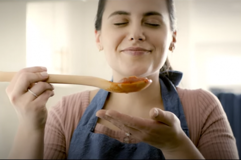 Woman cooking tomato sauce